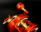 Slow Pitch Conventional Jigging Reel, Right Hand, Red Gold – product photo